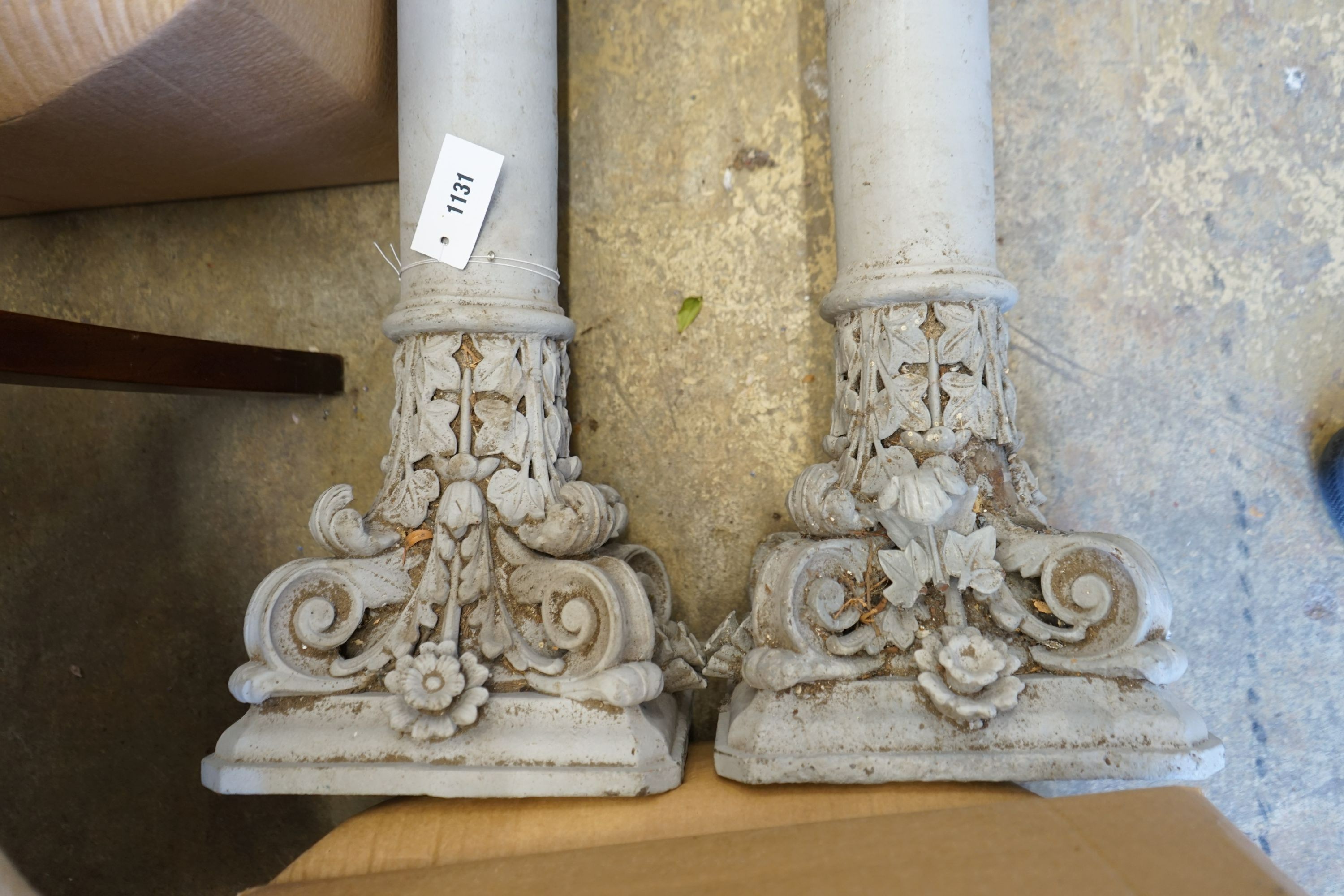 A pair of Victorian painted cast iron Corinthian columns, by repute from a West London Railway station, now demolished, height 252cm